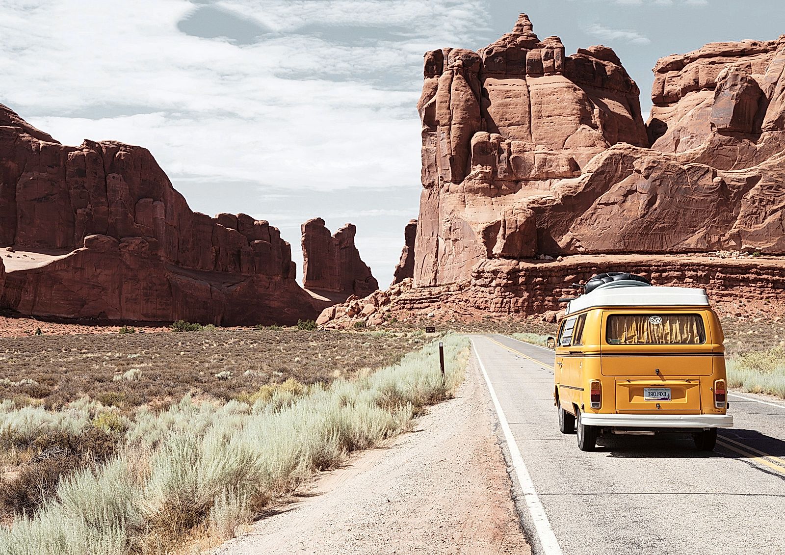 Yellow Volkswagen van on road.
