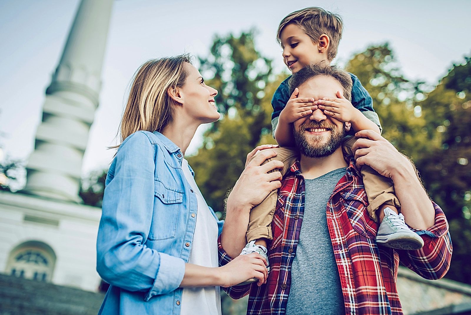 Happy family is having fun outdoors. Father, mother and son are spending time together.